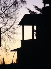 Low angle view of silhouette trees against sky