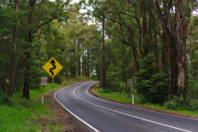 Road sign by trees