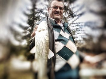 Portrait of smiling man in snow