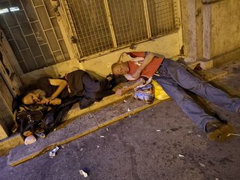 People sleeping on street in city