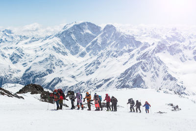 Group of people on snowcapped mountain