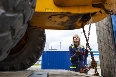 Woman working with construction vehicle