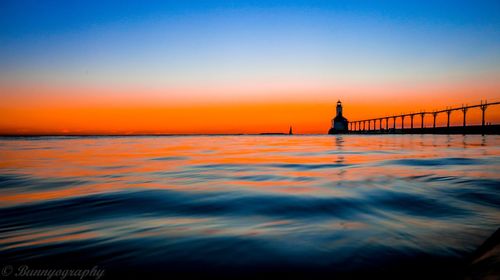 Silhouette of man in sea at sunset