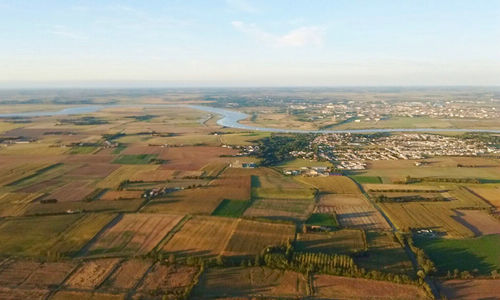 Aerial view of agricultural field against sky