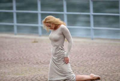 Full length of young woman exercising in gym