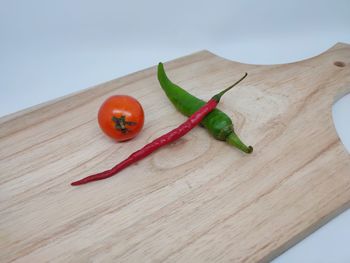 High angle view of red chili peppers on cutting board