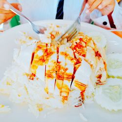 High angle view of hand holding ice cream in plate