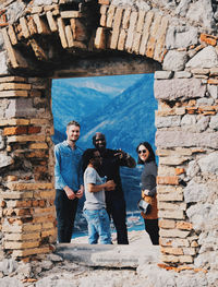 Full length of man standing against wall