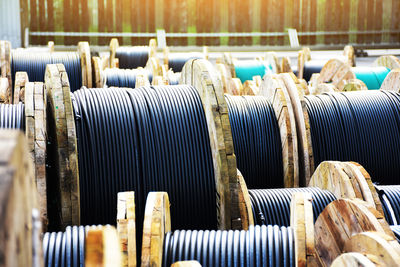 Wooden coils of electric cable outdoor. high and low voltage cables in the storage.