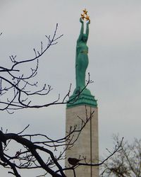 Low angle view of bare tree against sky