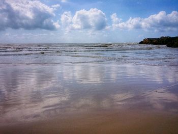 Scenic view of sea against cloudy sky