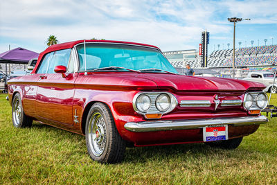 Graffiti on old car against sky
