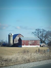 Farm on field against sky