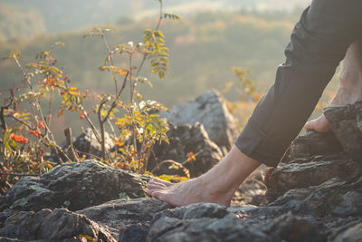 Elderly man relaxes with his bare feet in the warm sun