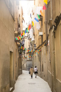 Rear view of people walking on street