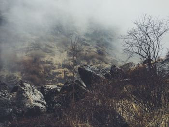 High angle view of rock formations on himalayas during foggy weather