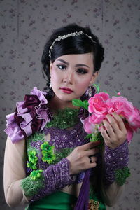 Portrait of woman with pink roses