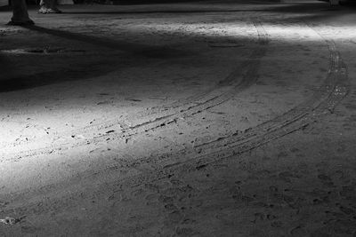 High angle view of tire tracks on wet road