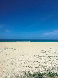 Scenic view of sea against blue sky