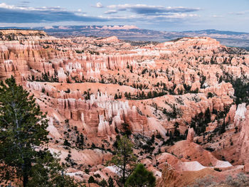 Aerial view of rock formations against cloudy sky