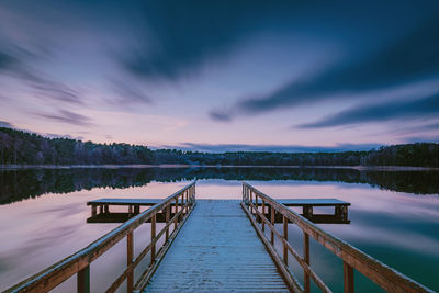 Pier over lake against sky