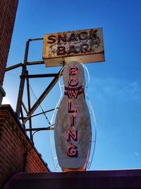 Low angle view of information sign against blue sky