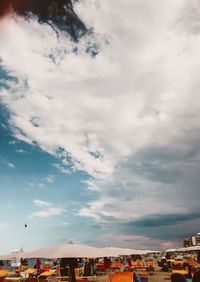 Buildings in city against cloudy sky