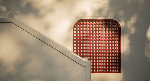 Low angle view of telephone booth against sky