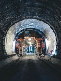 People in illuminated tunnel