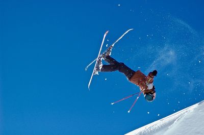 Low angle view of man against blue sky