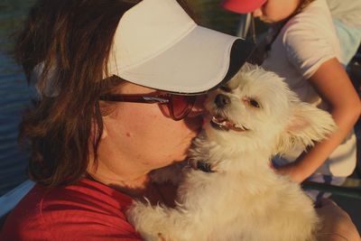 Close-up of mature woman kissing dog