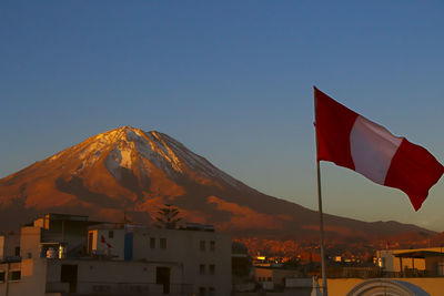 Peru flag against mountain range at sunset