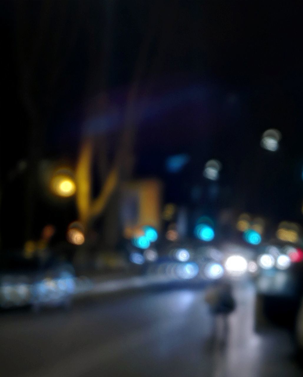 DEFOCUSED IMAGE OF ILLUMINATED CITY STREET