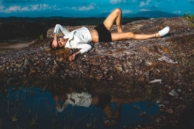 Woman lying on shore