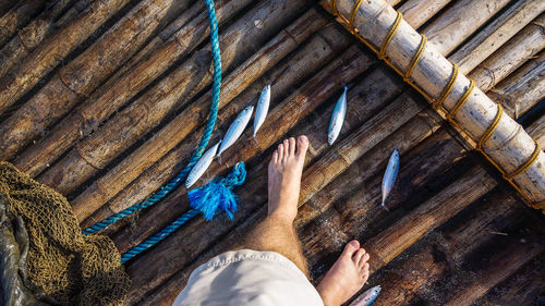 Low section of man on wooden floor