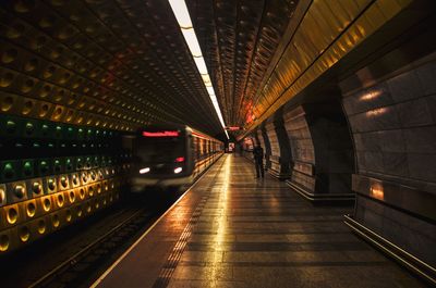 Illuminated train at railroad station platform