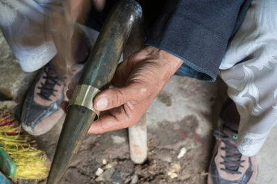 Midsection of man working on wood