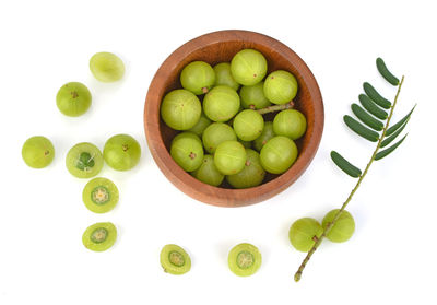 High angle view of fruits in bowl over white background