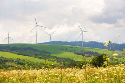 Wind turbines, sunny summer mountain landsape. green ecological power energy generation. wind farm 