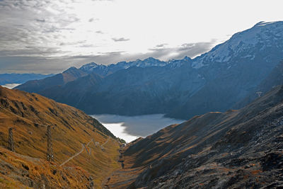 Scenic view of mountains against cloudy sky