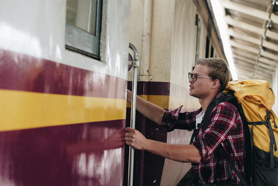 Side view of man entering in train