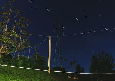 Low angle view of trees against sky at night