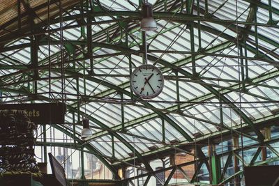 Low angle view of clock hanging on ceiling