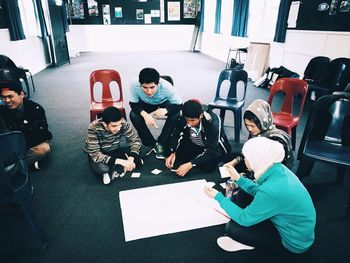 High angle view of people working on table