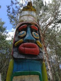 Low angle view of statue against trees