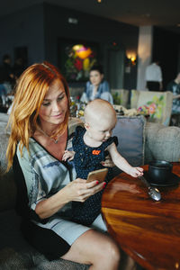 Mother with baby girl in cafe