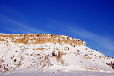 Scenic view of mountain against blue sky