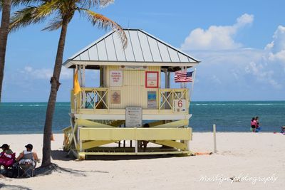 Lifeguard hut on beach against sky