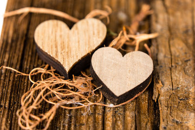 Close-up of heart shape made of bread on wood