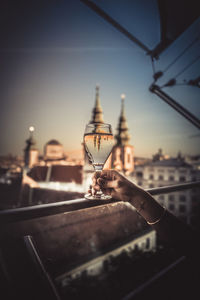 Close-up of coin-operated binoculars against cityscape